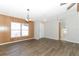 Open dining area with wood-paneled walls and vinyl flooring at 165 Moss Dr, Debary, FL 32713