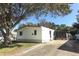 Single-wide mobile home with carport and mature tree in front at 165 Moss Dr, Debary, FL 32713