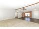 Spacious living room with carpet, wood-look flooring, and ceiling fan at 165 Moss Dr, Debary, FL 32713