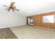 Living room with wood-paneled accent wall and access to patio at 165 Moss Dr, Debary, FL 32713