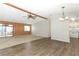 Spacious living room with wood-paneled accent wall and sliding glass doors at 165 Moss Dr, Debary, FL 32713