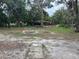 Large backyard with mature trees and space for outdoor activities at 1730 N Orange St, Mount Dora, FL 32757