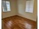 Bright bedroom with wood flooring and large window at 1730 N Orange St, Mount Dora, FL 32757