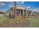 Landscaped front yard with palm tree and red plants at 3571 Dahlia Dr, Haines City, FL 33844