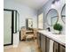 Elegant bathroom with dual vanities and a walk-in shower at 4217 Sky Flower Ln, St Cloud, FL 34772