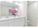 Double vanity bathroom with a large mirror and toilet at 4701 New Orleans Cv, Oviedo, FL 32765