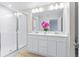 Bathroom with double vanity, large mirror and shower at 4701 New Orleans Cv, Oviedo, FL 32765