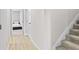 Hallway with light gray walls, wood-look floors, and bedroom view at 4701 New Orleans Cv, Oviedo, FL 32765