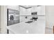 Modern kitchen with white cabinets, stainless steel appliances, and quartz countertops at 4701 New Orleans Cv, Oviedo, FL 32765