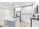 Modern kitchen with white cabinets, stainless steel appliances, and quartz countertops at 4701 New Orleans Cv, Oviedo, FL 32765