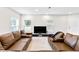 Open concept living area with brown leather sectional and kitchen view at 4701 New Orleans Cv, Oviedo, FL 32765