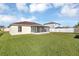 House with a large backyard and screened patio at 610 Crane Dr, Poinciana, FL 34759