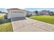 House exterior showing a driveway and well-kept lawn at 610 Crane Dr, Poinciana, FL 34759