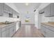 Efficient kitchen with gray cabinets and tile flooring at 610 Crane Dr, Poinciana, FL 34759