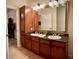 Double vanity bathroom with granite countertop and large mirror at 904 Charo Pkwy # 536, Davenport, FL 33897