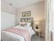 Bedroom with neutral wall tones and a blush-colored blanket at 920 Pearlwood Loop, Eagle Lake, FL 33839