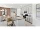 Kitchen island with granite countertop and seating at 920 Pearlwood Loop, Eagle Lake, FL 33839