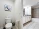 Bathroom with toilet, double vanity, and bathtub at 1264 Challenge Dr, Davenport, FL 33896