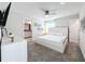 King-size bed, ceiling fan, en-suite bathroom access at 1264 Challenge Dr, Davenport, FL 33896