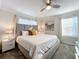 Bright bedroom with king-size bed, ceiling fan, and large windows at 1264 Challenge Dr, Davenport, FL 33896