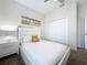 Bedroom with white platform bed and a modern, minimalist aesthetic at 1264 Challenge Dr, Davenport, FL 33896