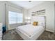 Bright bedroom with a white platform bed, large window and modern decor at 1264 Challenge Dr, Davenport, FL 33896