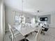 Modern dining room with marble top table and white chairs at 1264 Challenge Dr, Davenport, FL 33896