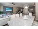 Elegant dining room with marble table and modern white chairs at 1264 Challenge Dr, Davenport, FL 33896