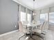 Modern dining room featuring marble table and six white chairs at 1264 Challenge Dr, Davenport, FL 33896