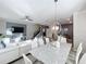 Open concept dining room with marble table and white chairs at 1264 Challenge Dr, Davenport, FL 33896
