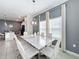 Modern dining room with a marble table and six white chairs at 1264 Challenge Dr, Davenport, FL 33896