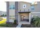 Contemporary townhome with gray facade and modern entryway at 1264 Challenge Dr, Davenport, FL 33896