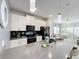 Spacious kitchen with white cabinets, gray countertops, and breakfast bar at 1264 Challenge Dr, Davenport, FL 33896