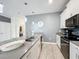 Modern kitchen with a large island, white cabinets, and gray walls at 1264 Challenge Dr, Davenport, FL 33896