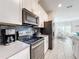 Kitchen with stainless steel appliances and dark gray backsplash at 1264 Challenge Dr, Davenport, FL 33896