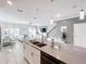 Open kitchen island with double sinks, overlooking living and dining area at 1264 Challenge Dr, Davenport, FL 33896