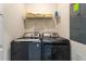 Modern laundry room with washer, dryer, and shelving at 1264 Challenge Dr, Davenport, FL 33896