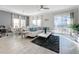Bright living room with white sectional sofa, large windows, and patio access at 1264 Challenge Dr, Davenport, FL 33896