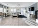 Bright living room with white sectional and dining area at 1264 Challenge Dr, Davenport, FL 33896