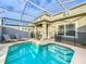 Relaxing screened-in pool area with lounge chairs and a dining table at 1264 Challenge Dr, Davenport, FL 33896
