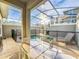Enjoy this private pool with a screened enclosure and patio furniture at 1264 Challenge Dr, Davenport, FL 33896