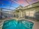 Inviting screened-in pool with lounge chairs and patio furniture at 1264 Challenge Dr, Davenport, FL 33896
