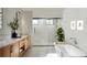 Spa-like bathroom with a freestanding tub, double vanity, and walk-in shower at 227 Page St, Orlando, FL 32806