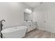 Elegant bathroom featuring a freestanding tub, double vanity, and wood-look tile floor at 4479 Sw 170Th Rd, Ocala, FL 34473