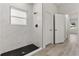 Modern bathroom with walk-in shower, marble tile and honeycomb floor at 4479 Sw 170Th Rd, Ocala, FL 34473