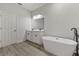 Modern bathroom with double vanity and a freestanding bathtub at 4479 Sw 170Th Rd, Ocala, FL 34473