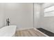 Bathroom with freestanding tub and a walk-in shower with marble tile at 4479 Sw 170Th Rd, Ocala, FL 34473
