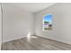 Spacious bedroom with a window offering a view and wood-look floors at 4479 Sw 170Th Rd, Ocala, FL 34473