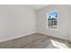 Bright bedroom with a large window, wood-look floors, and neutral walls at 4479 Sw 170Th Rd, Ocala, FL 34473