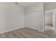 Well-lit bedroom featuring double door closet and wood-look floors at 4479 Sw 170Th Rd, Ocala, FL 34473